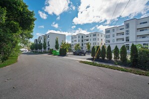 A modern residential area with multi-story buildings, a clear sky, and a paved road. - Cityscape Condo: New in Downtown Traverse City! (Traverse City)