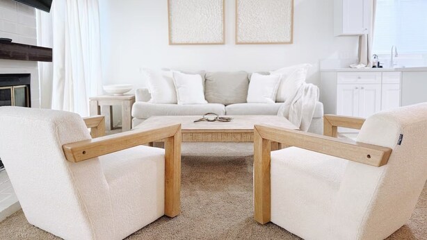 A modern living room with a white sofa, two armchairs, a coffee table, and a flat-screen TV mounted on the wall. - The Cozy Abode On Beagle Street- 3BR 2BA -Sleeps 16- Pool (San Diego)