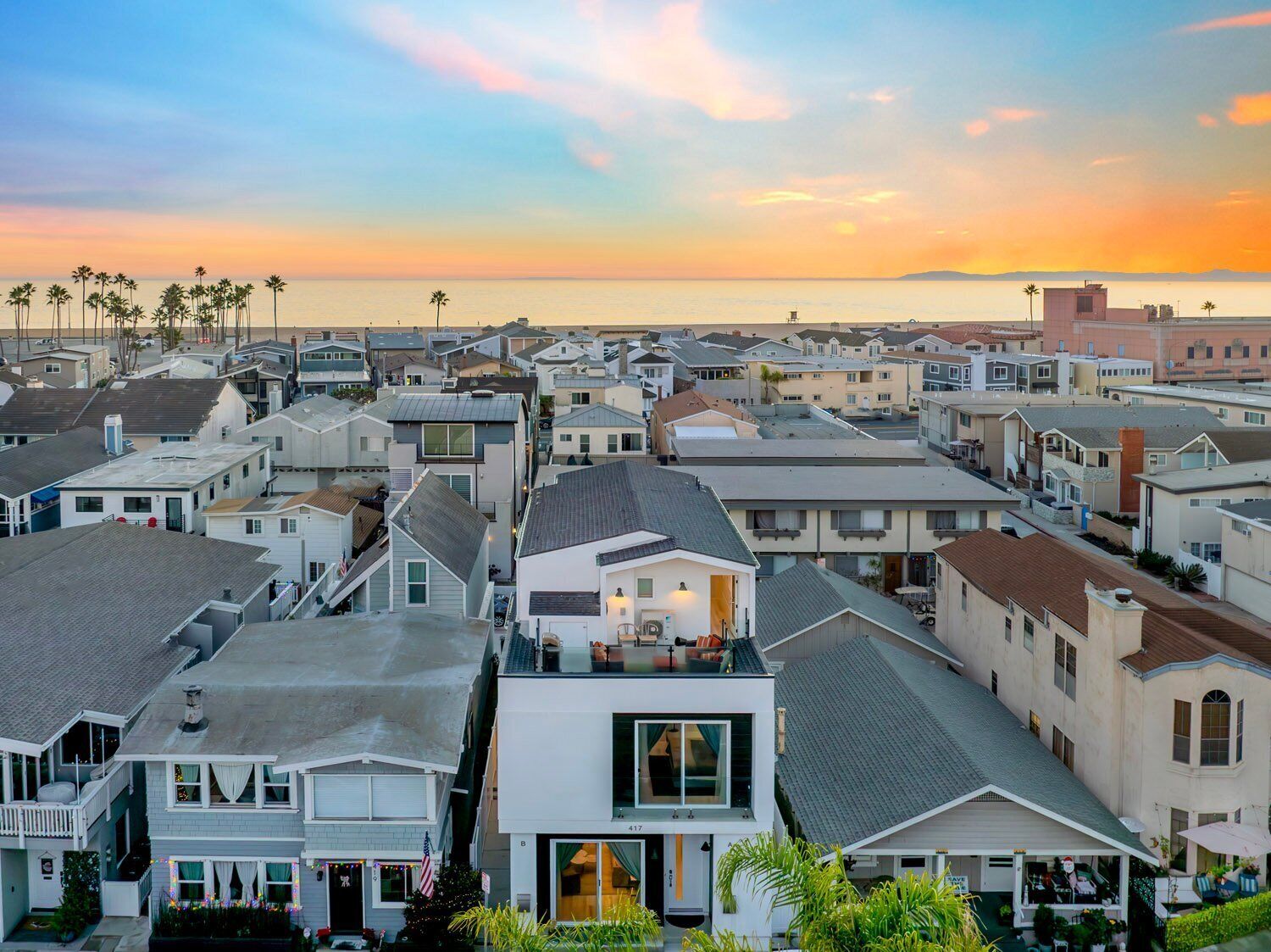 A coastal residential area with a variety of houses, some with balconies and others with front yards.