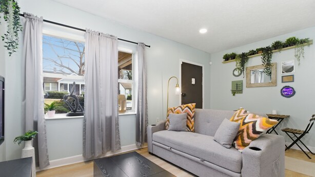 A living room with a grey sofa, a black coffee table, and a window with grey curtains. - 2 Bedroom Near Beltline, Mercedes Benz Stadium & State Farm Arena (Atlanta)
