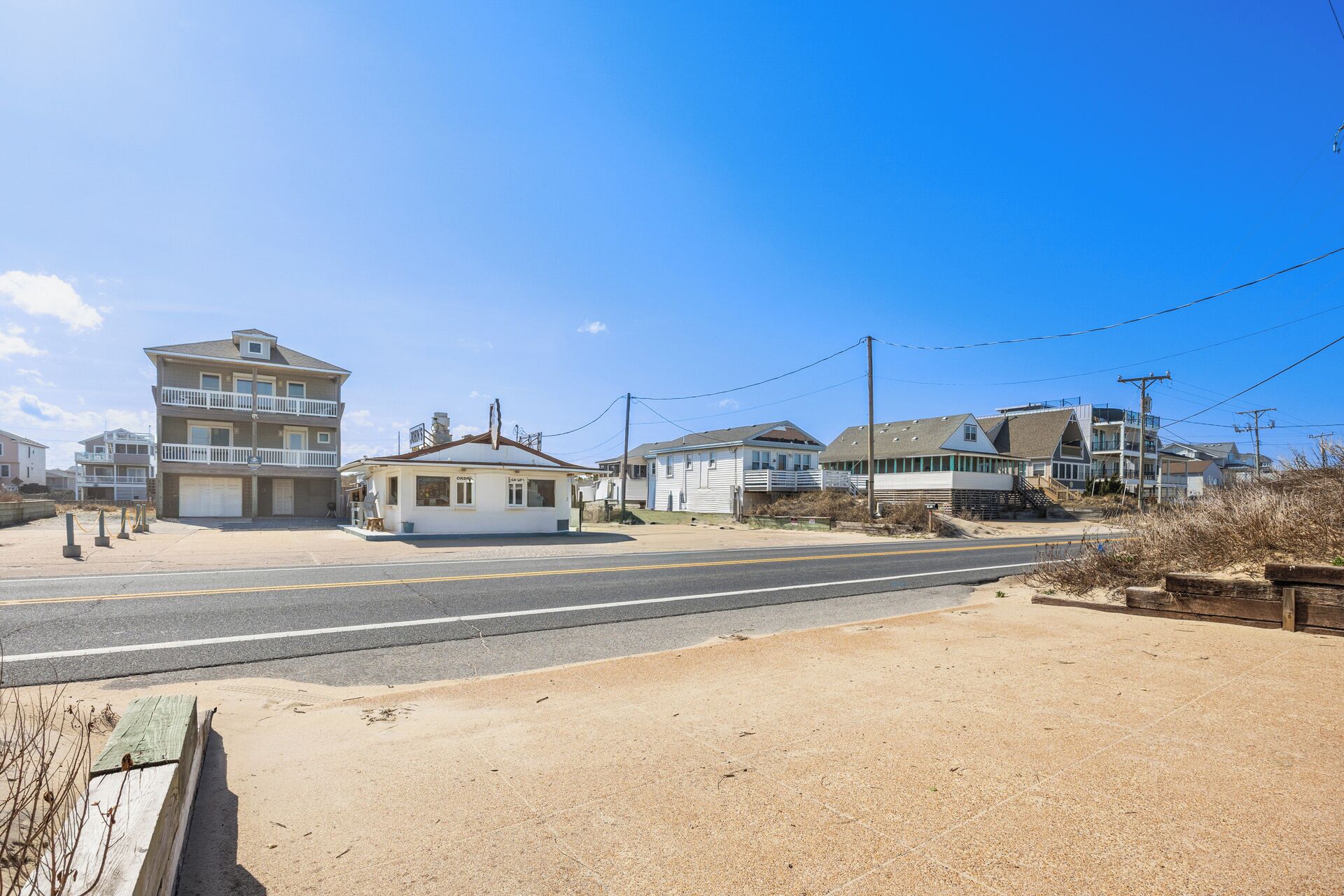 A coastal road with a small building labeled "Ocean View" and a larger multi-story building with balconies.