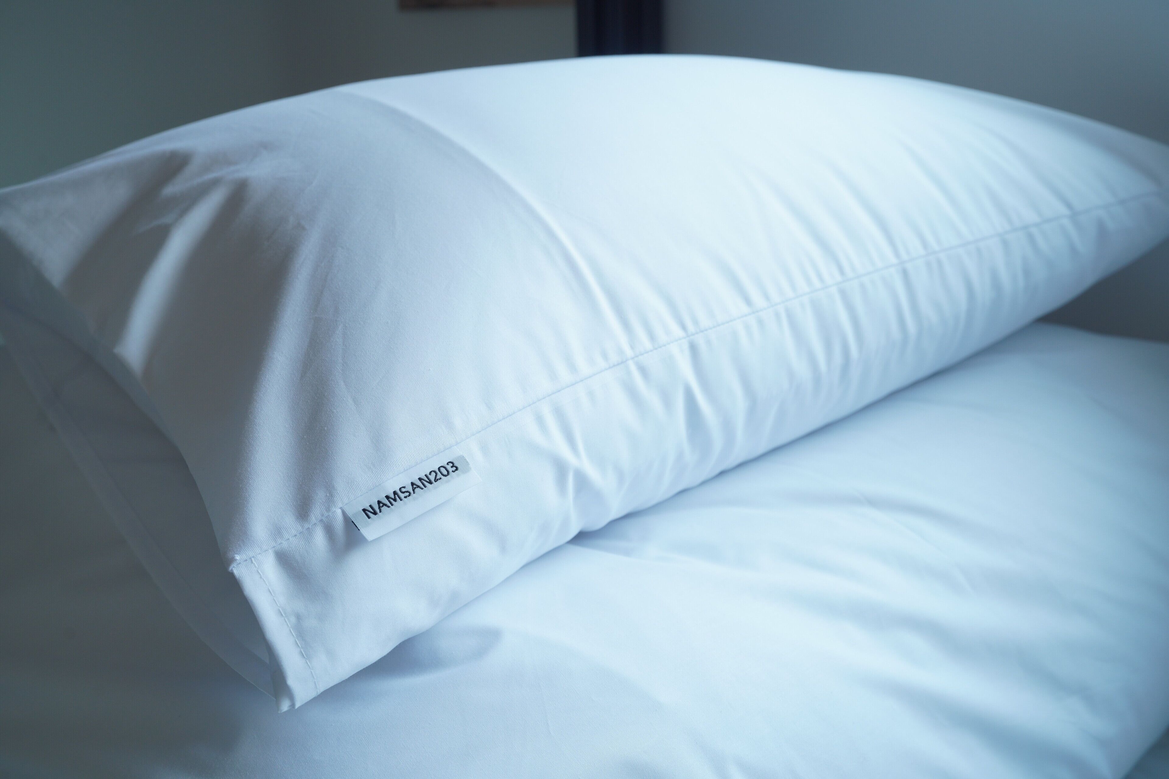 A white pillow with a label on it.