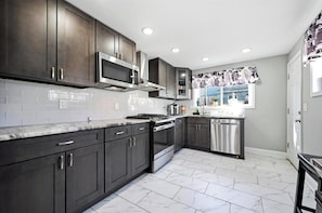 Coffee/tea maker, fridge, microwave, oven