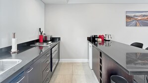 Una cocina moderna con una isla central, un lavamanos y un refrigerador.