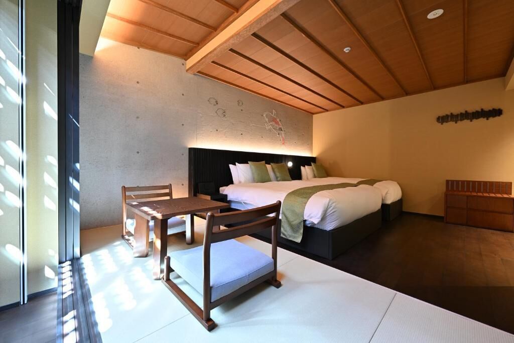 A bedroom with a bed, bedside table, chair, and a wall with a map.