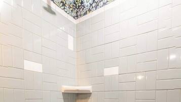 A bathroom with a bathtub, a shower, and a toilet.