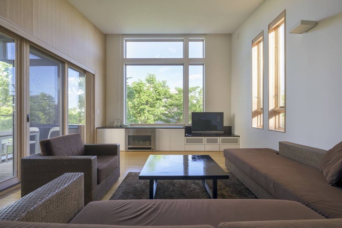 A modern living room with a sofa set, a coffee table, and a television.