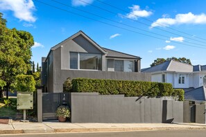 A modern two-story house with a grey exterior, large windows, and a well-maintained hedge. - Fully Furnished house 89 day option (Vaucluse)