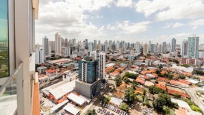A cityscape with high-rise buildings, a mix of residential and commercial structures, and a clear sky.