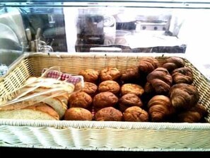 A wicker basket filled with various baked goods, including bread and pastries. - Hotel De L Aqua (Miyakojima)