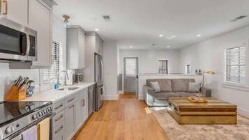 Fridge, stovetop, dishwasher, coffee/tea maker