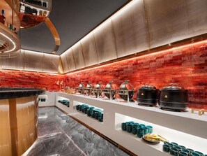A modern kitchen with a marble floor, a red brick backsplash, and stainless steel appliances. - Echerm Hotel Wuyangcun Metro Station (Guangzhou)