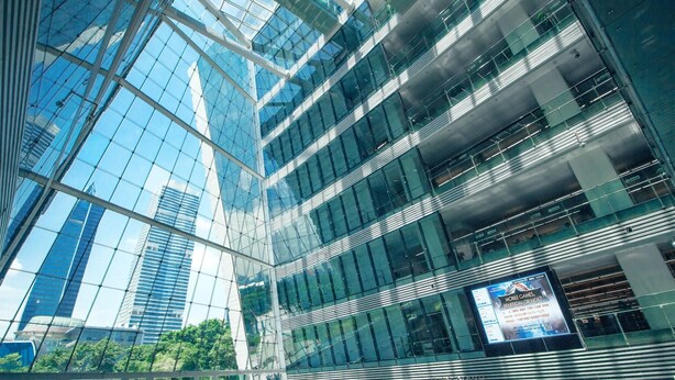 A modern building with a glass facade and multiple floors. - Echerm Hotel Wuyangcun Metro Station (Guangzhou)