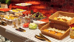A buffet with various food items including pastries, salads, and bread. - Echerm Hotel Wuyangcun Metro Station (Guangzhou)