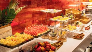 A buffet with various food items including fruits, pastries, and condiments. - Echerm Hotel Wuyangcun Metro Station (Guangzhou)