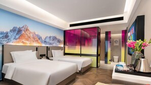 A modern hotel room with a large bed, a desk with a computer, and a vibrant mountain mural on the wall. - Echerm Hotel Wuyangcun Metro Station (Guangzhou)