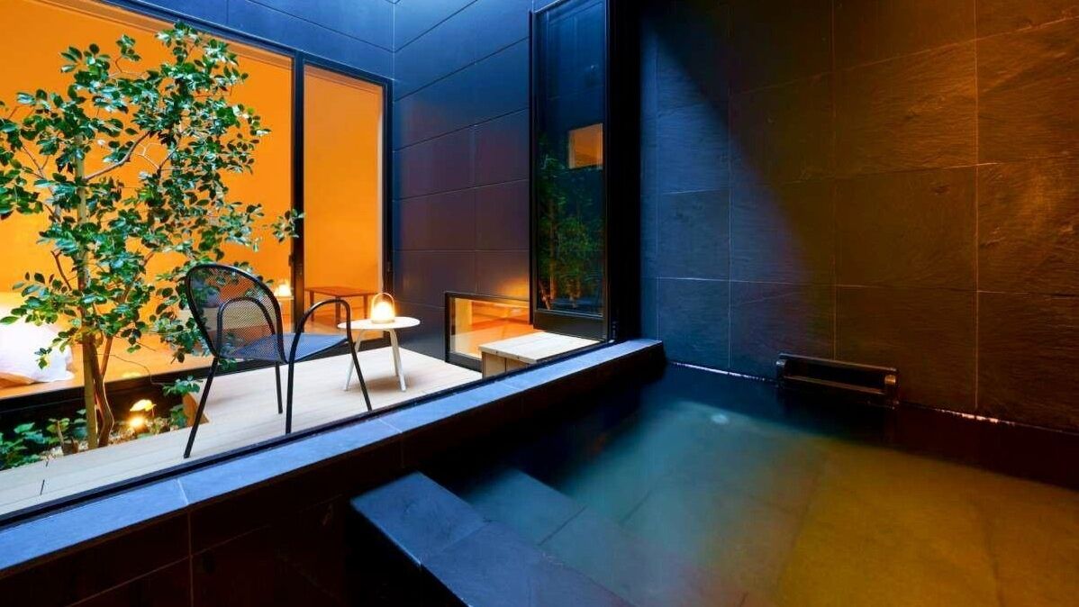 A modern interior with a seating area, a small table, and a plant.