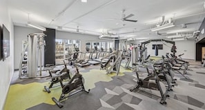 A gym with cardio machines, weightlifting equipment, and a punching bag. - Luxury High-Rise, Walk to Broadway, Pool + Sky Lounge, coffee essentials (Nashville)