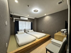 A hotel room with two beds, a desk, a chair, and a window with curtains. - Ruka Hotel Tennoji (Osaka)