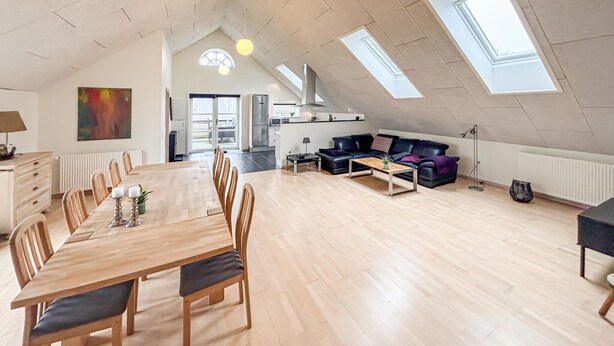 A spacious loft with a dining area, living space, and skylights. - Amazing apartment in Nørre Nebel (Nørre Nebel)