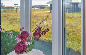 A window with a view of a grassy field and buildings in the distance. - 3 bedroom gorgeous home in Hvide Sande (Hvide Sande)