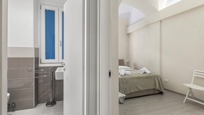 A hotel room with a bed, a chair, a sink, and a window. - Garibaldi - Loano Centre Apartment for 4, Loano, Italy (Loano)