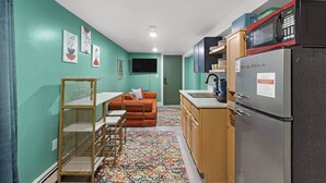 A compact kitchen with a refrigerator, microwave, and sink. - Cheerful Rainbow Suite • Near NYC (Jersey City)