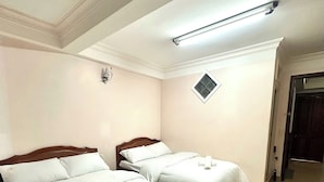 A hotel room with two beds, a ceiling light, a small window, and a door. - Yên hostel (Cam Ly - Da Lat)