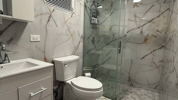 Shower, towels, soap, toilet paper