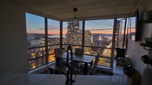 A high-rise room with a city view, a dining area, and a kitchen. - 29th Floor Condo in Yaletown. Message me at a.hostacny@gmail.com for details 
 (Vancouver)