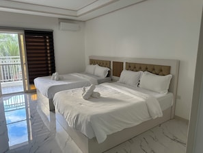 Family Double Room, Balcony | Living area - OYUSTAY Clark condo near airport casino (Mabalacat City)