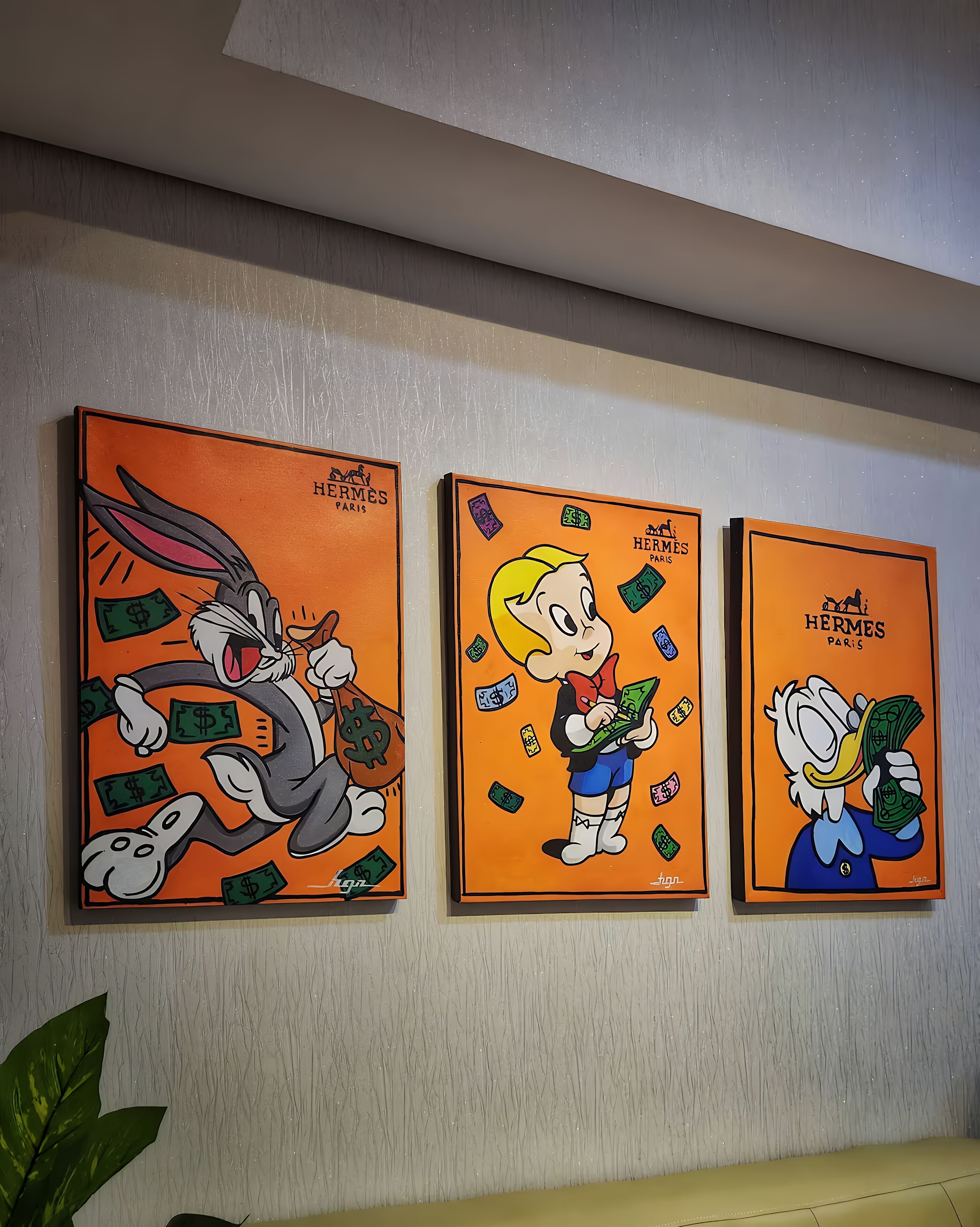Three framed artworks on a wall.