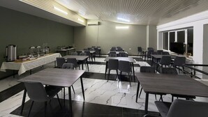 A conference room with tables and chairs, a buffet area, and a large window. - Nana Grand Hotel (Yerevan)