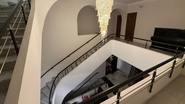 A multi-level interior with a grand staircase, a chandelier, and a piano. - Nana Grand Hotel (Yerevan)