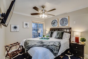 A bedroom with a bed, a ceiling fan, a window, and artwork on the walls. - 5BR Hideaway w/ Heated Pool/Hot Tub/Billiards Table (Glendale)