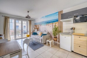 A modern apartment with a kitchen, dining area, and a balcony with a view. - Esprit Bassin – Balcony, pool, and nearby beaches (Pyla sur Mer)