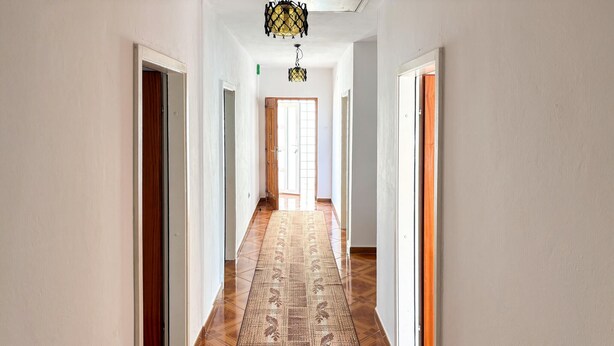 A hallway with wooden flooring, white walls, and doors on both sides. - 3 bedroom pet friendly apartment in Senj (Senj)