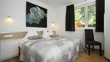 Deluxe Apartment, Patio, Garden View | In-room safe, laptop workspace, soundproofing, iron/ironing board