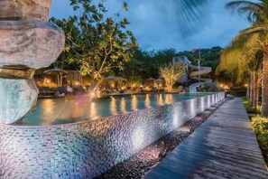 A pool with a tiled edge, a wooden deck, and a waterfall feature. - High Floor Sea View 2 Bed Room (Bang Lamung District)