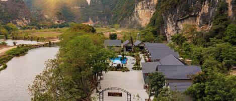 Un complexe hôtelier doté d’une piscine, de chambres et offrant une vue sur les montagnes environnantes.