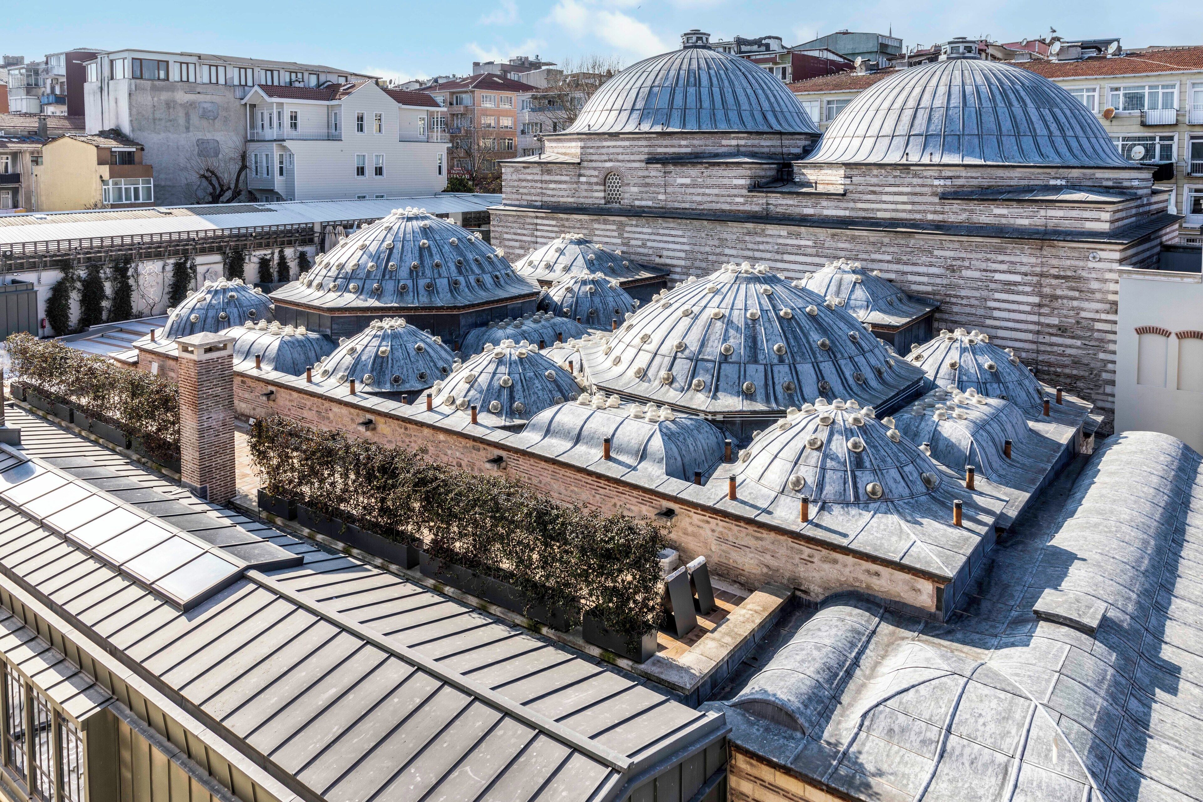 A building with multiple domed roofs and a brick facade.