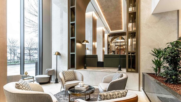 A modern interior with a seating area, large windows, and a central archway. - Mövenpick Istanbul Old Town (Istanbul)