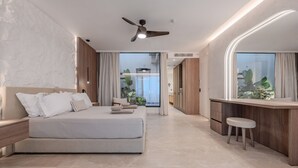 A modern bedroom with a large bed, a desk, and a view of the outdoors. - Domaine–Sun,Luxury Eco Villa, private pool, great view (Chersonissos)