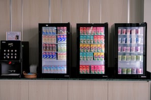 Three beverage vending machines with various drink options. - One Budget Hotel Chiangrai Chiangsaen 2 (Chiang Saen)