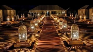 A pathway lined with ornate lanterns leading to a building with a dome roof. - Desert Luxury Camp (Merzouga)