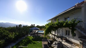 Eine Villa mit Schwimmbad, überdachter Terrasse und Bergblick.