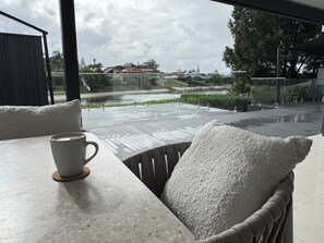 Outdoor dining - Waterfront retreat with jetty, pool, waterslide and luxury comfort. (Mermaid Waters)