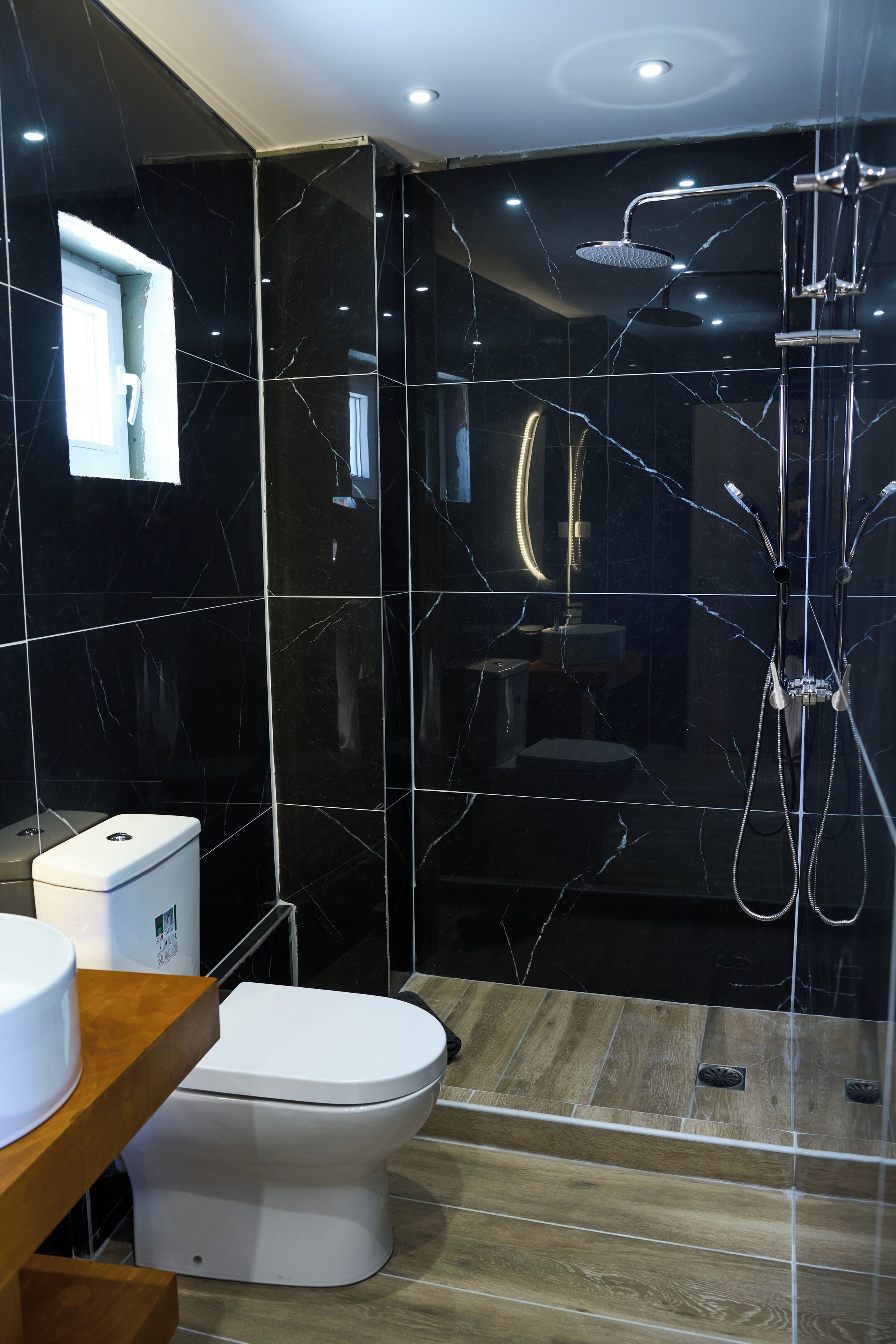 A modern bathroom with a toilet, bidet, and shower.