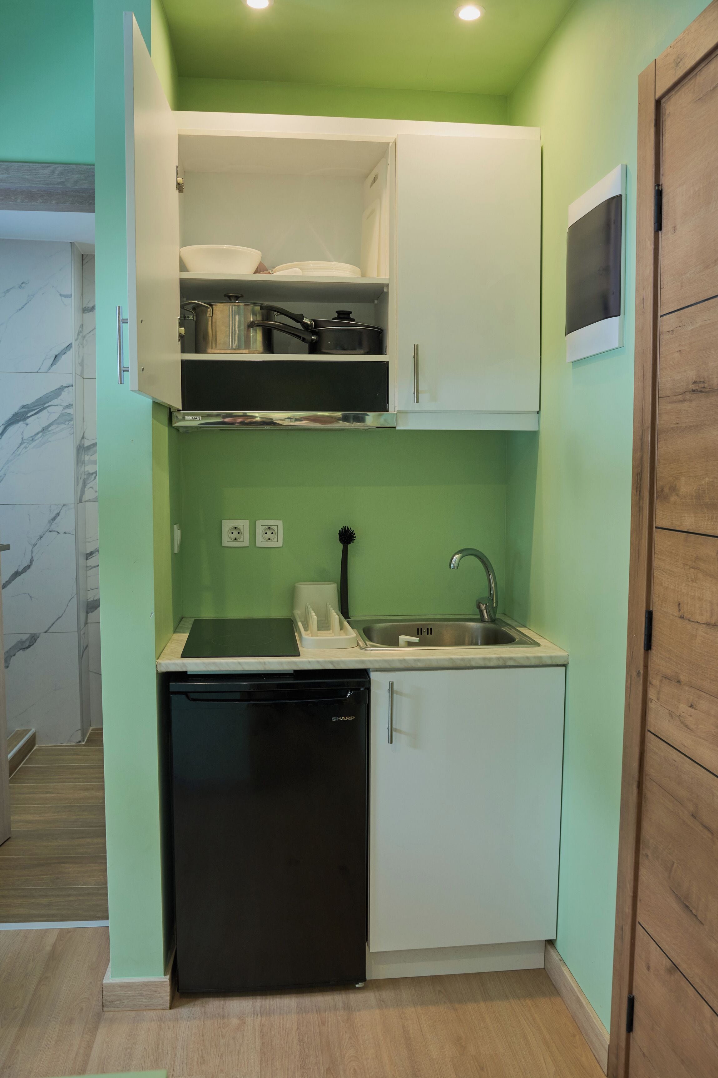 A compact kitchen with a dishwasher, a sink, and a countertop.