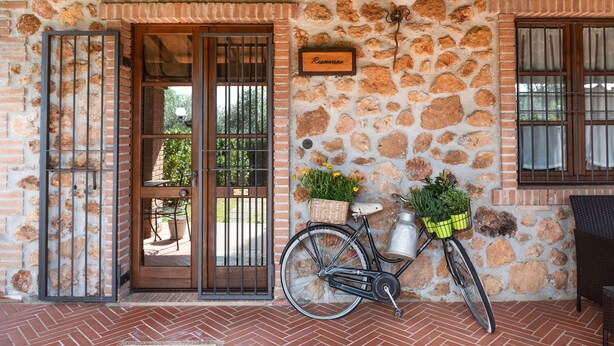 A stone building with a sign reading 'Ramos'.